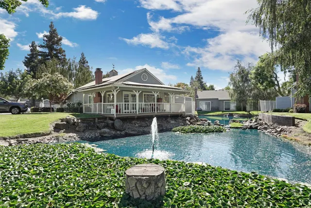 a front view of a house with a yard and a garage