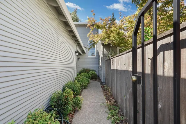 a path view of a house with a tree