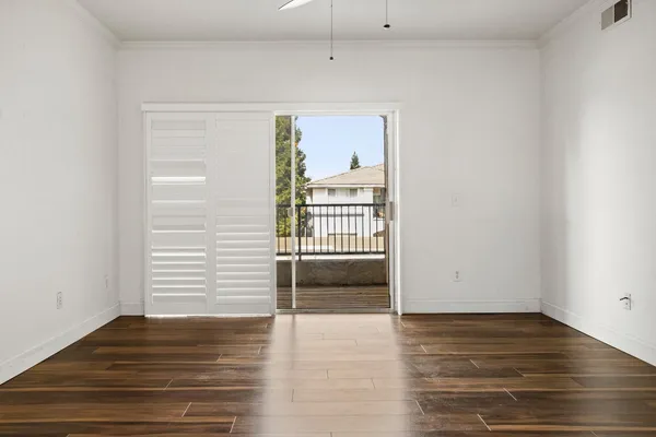 wooden floor in an empty room with a window