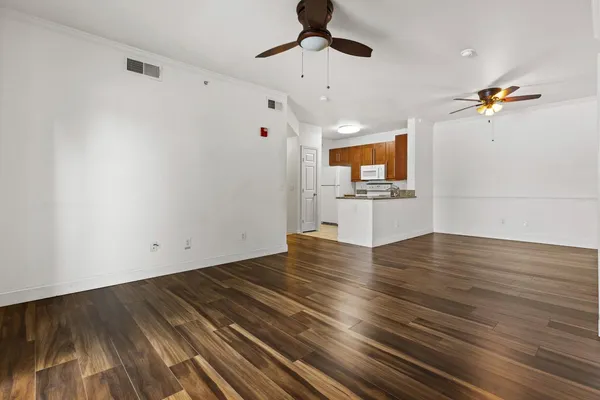 a view of empty room with wooden floor