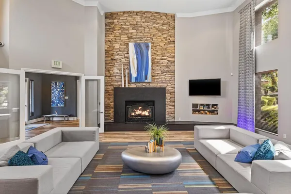 a living room with a fireplace and a flat screen tv