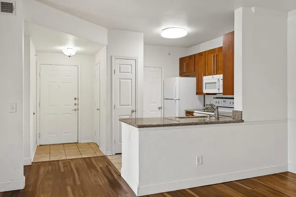 a kitchen with white cabinets and white appliances