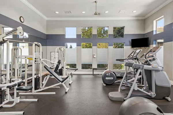 a view of a patio with a table and chairs under an umbrella