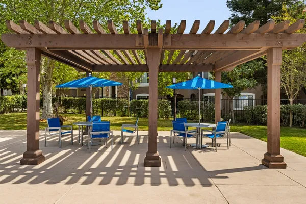a view of a chairs with an umbrella in the patio