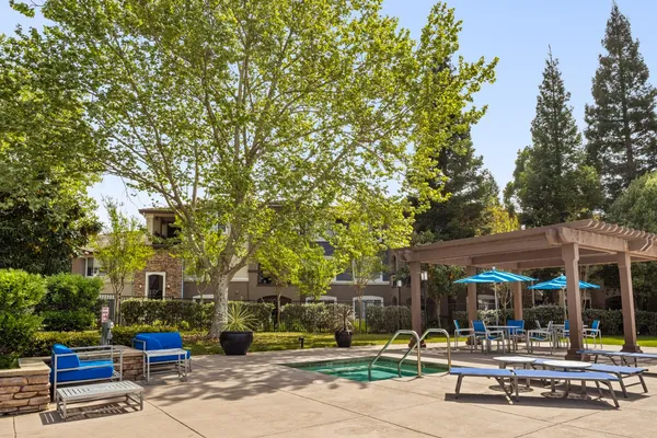 a tall white house with trees in the background
