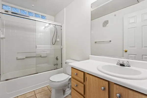 a kitchen with a sink granite counter tops and a view of living room