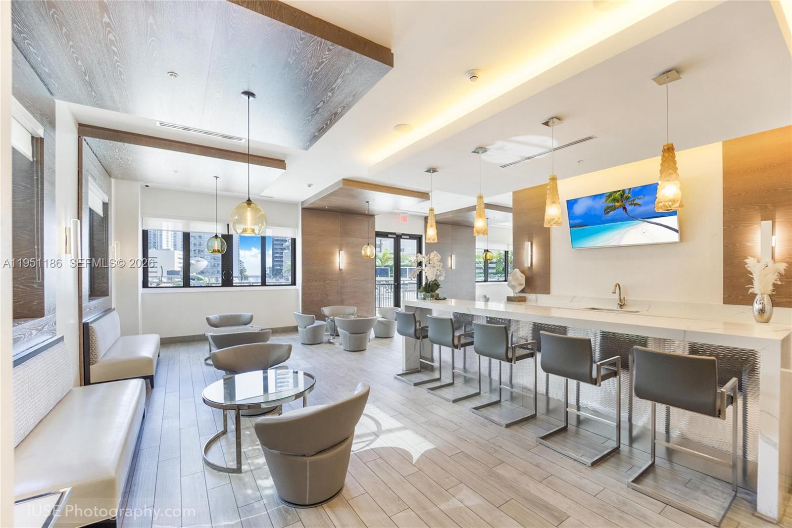999 Southwest 1st Avenue, Unit 1208 Miami, FL 33130 - Photo 11 of 17 a large living room with stainless steel appliances kitchen island granite countertop furniture and a large window