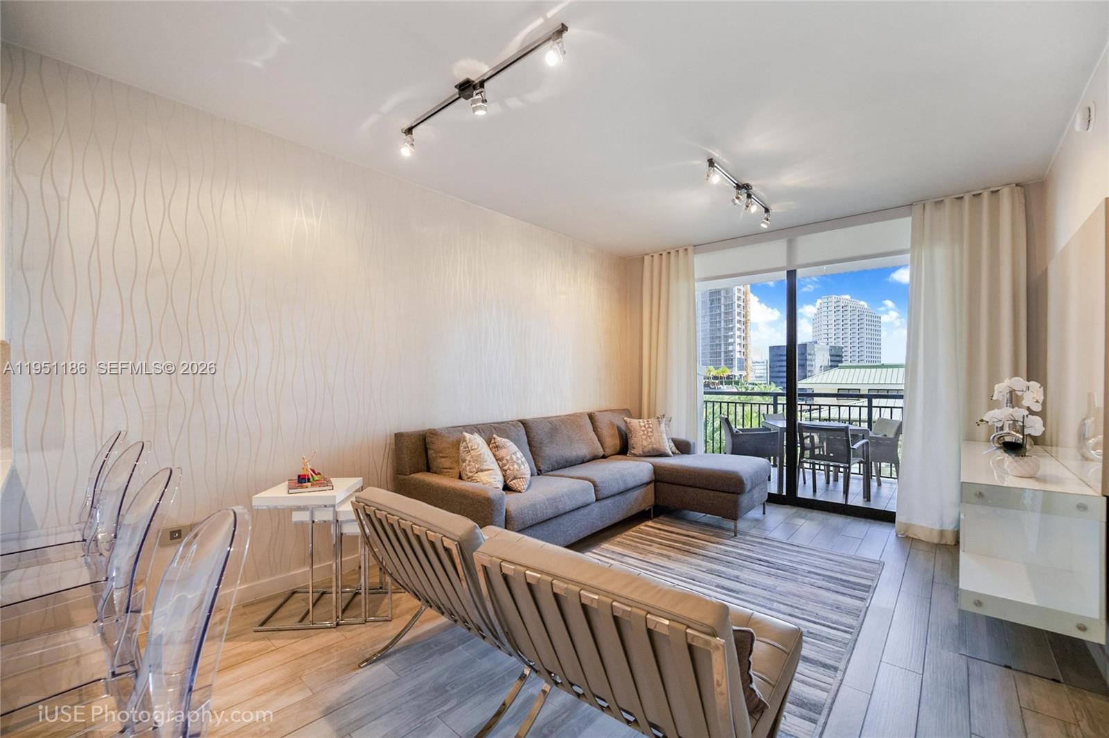 999 Southwest 1st Avenue, Unit 1208 Miami, FL 33130 - Photo 5 of 17 a living room with furniture and a large window