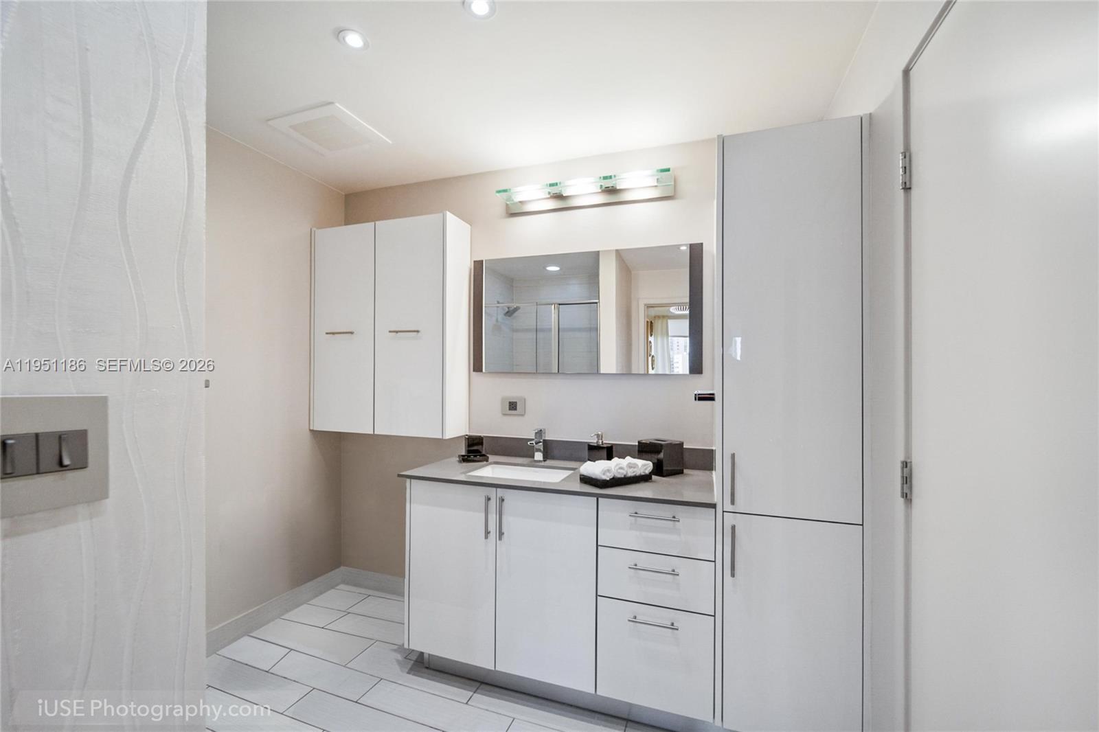999 Southwest 1st Avenue, Unit 1208 Miami, FL 33130 - Photo 9 of 17 a bathroom with a sink and a mirror