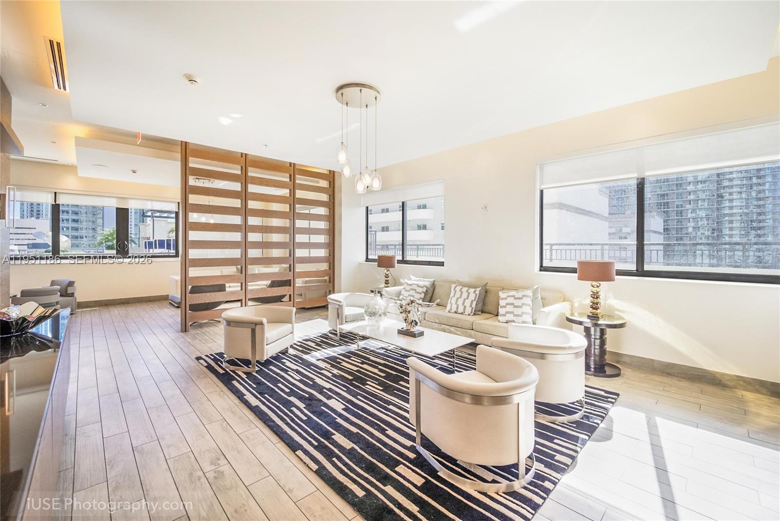 999 Southwest 1st Avenue, Unit 1208 Miami, FL 33130 - Photo 10 of 17 a very nice looking living room with a large window and wooden floor
