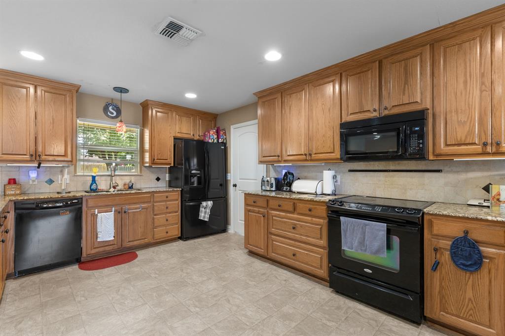 4504 Jennings Avenue Wichita Falls, TX 76310 - Photo 8 of 26 a kitchen with stainless steel appliances granite countertop a stove sink microwave and refrigerator
