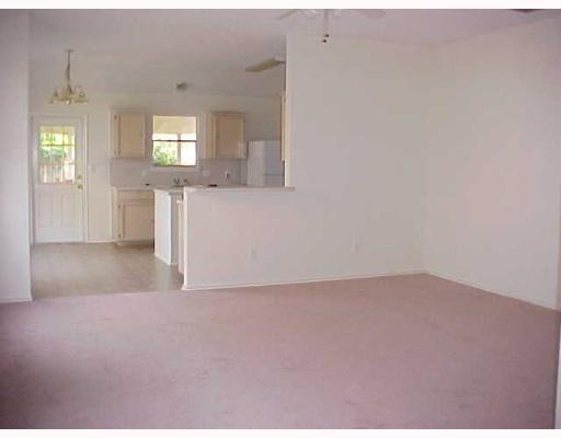 7925 Elk Drive, Unit 1 Corpus Christi, TX 78414 - Photo 2 of 8 a view of an empty room with wooden floor and windows