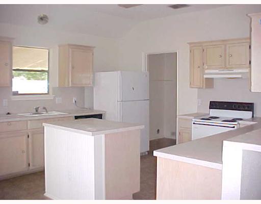 7925 Elk Drive, Unit 1 Corpus Christi, TX 78414 - Photo 3 of 8 a kitchen with a stove a refrigerator and a sink