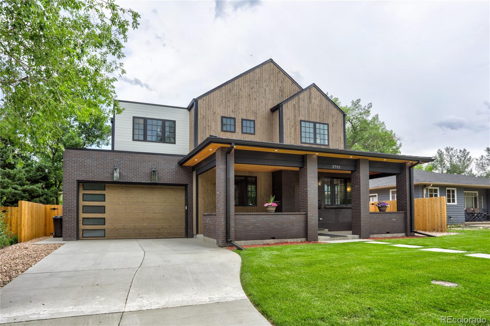 2732 South Jackson Street Denver, CO 80210 - Photo 1 of 40 a front view of a house with a yard and garage