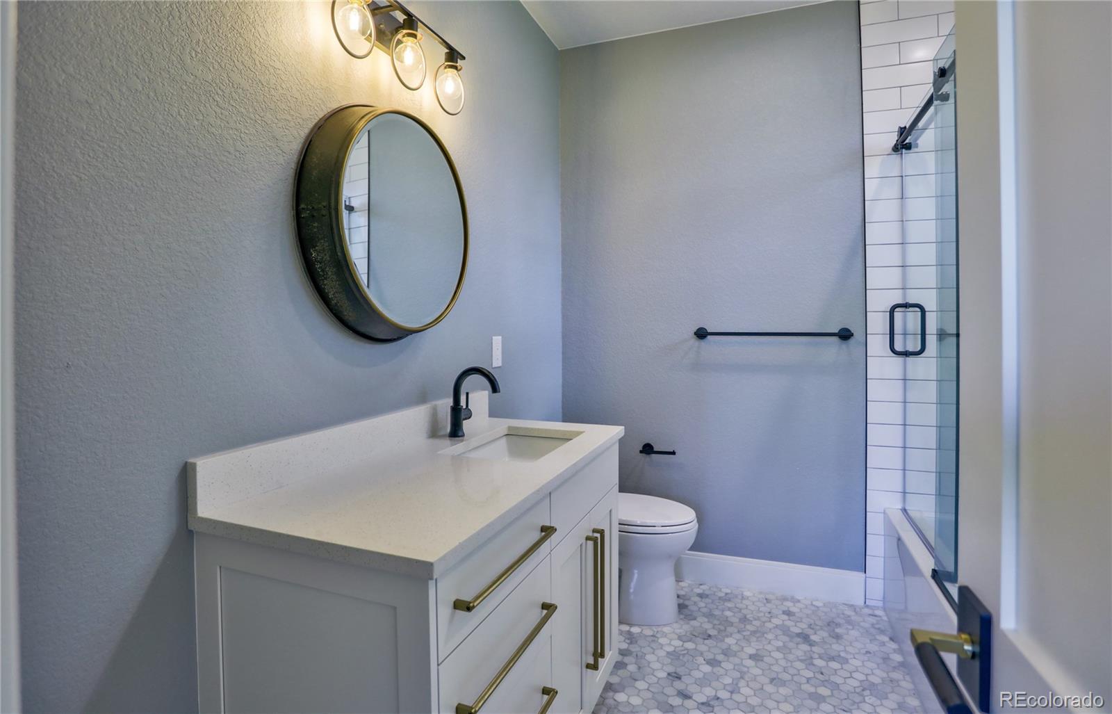 2732 South Jackson Street Denver, CO 80210 - Photo 19 of 40 a bathroom with a sink and a mirror