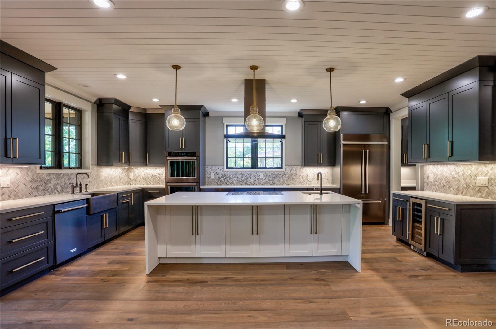 2732 South Jackson Street Denver, CO 80210 - Photo 22 of 40 a large kitchen with stainless steel appliances granite countertop a stove a sink and a refrigerator
