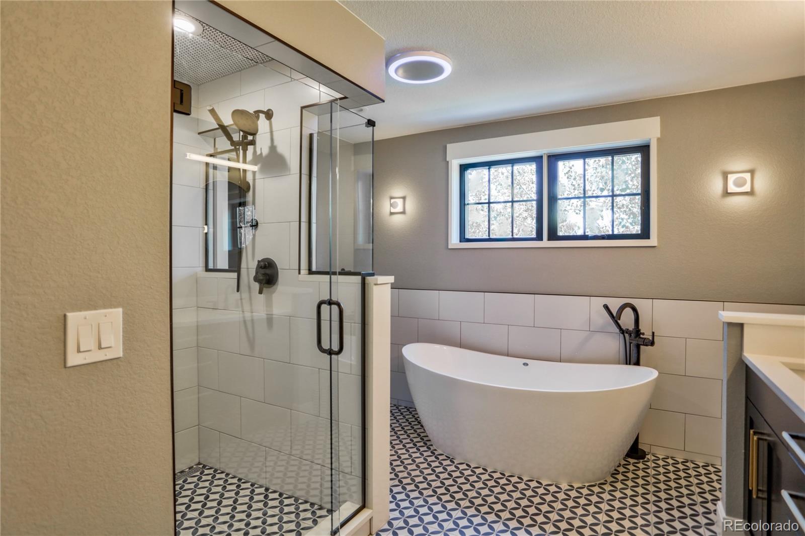2732 South Jackson Street Denver, CO 80210 - Photo 27 of 40 a bathroom with a bathtub and window