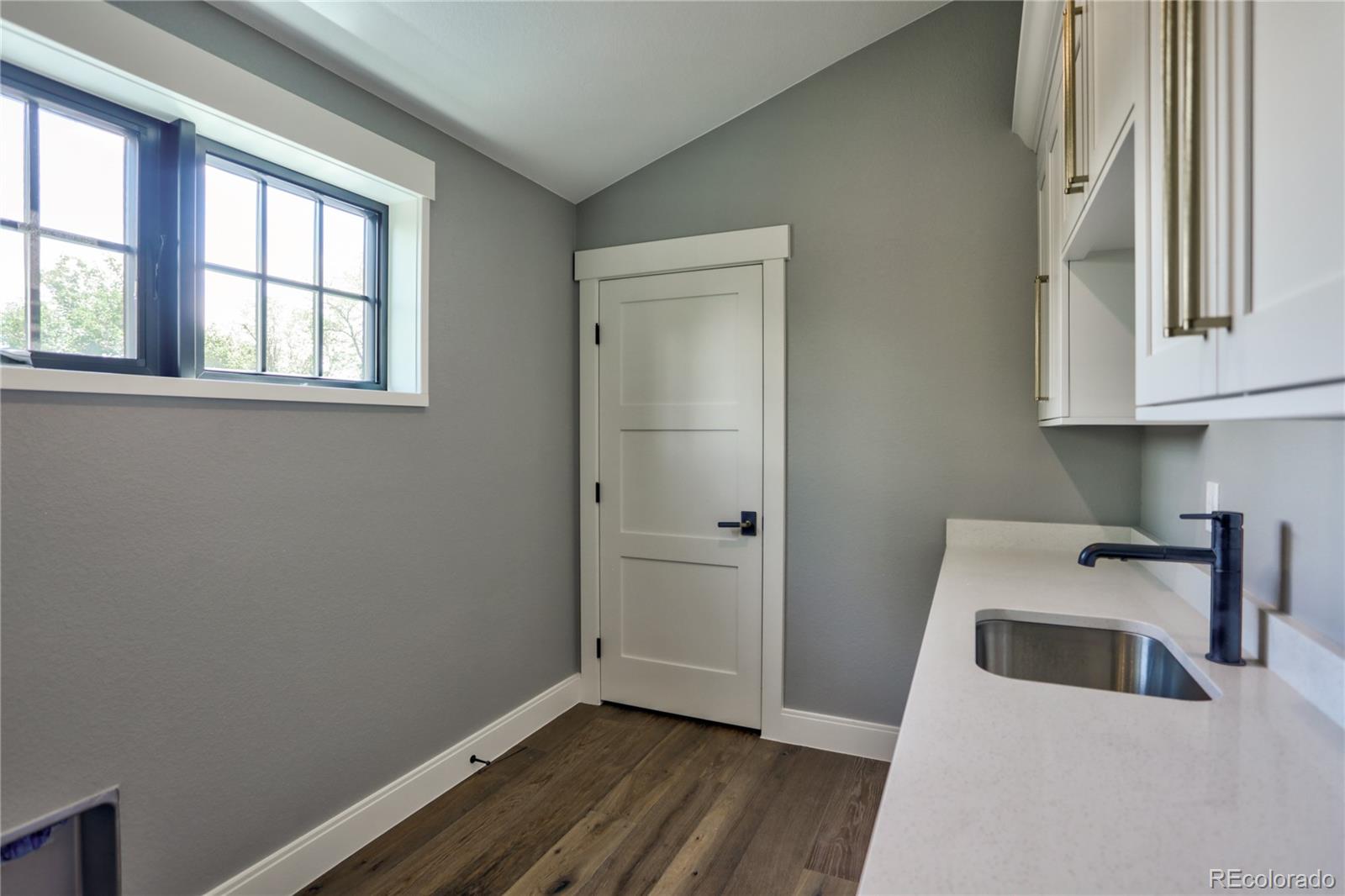 2732 South Jackson Street Denver, CO 80210 - Photo 30 of 40 a view of a room that has wooden floor washer and dryer