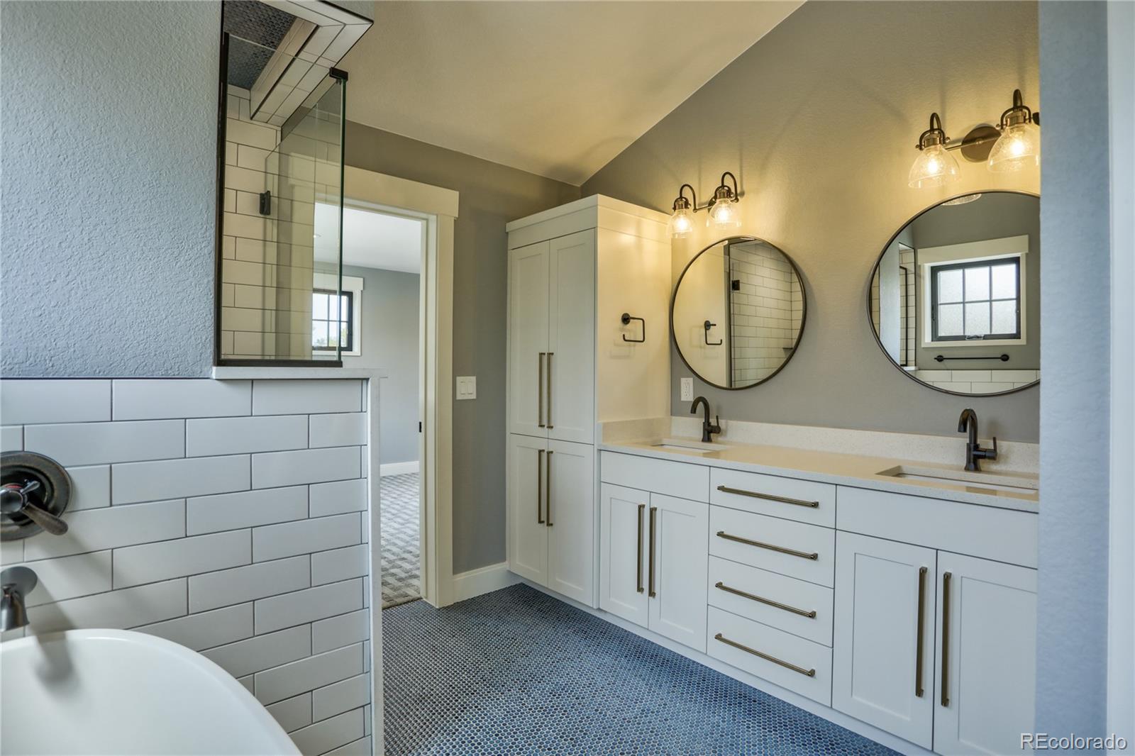 2732 South Jackson Street Denver, CO 80210 - Photo 32 of 40 a bathroom with 2 sink and a mirror