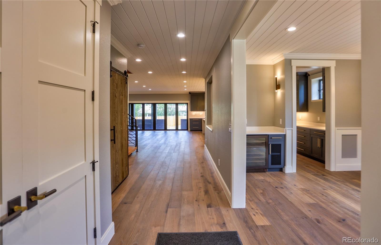 2732 South Jackson Street Denver, CO 80210 - Photo 6 of 40 a view of a hallway with wooden floor and staircase