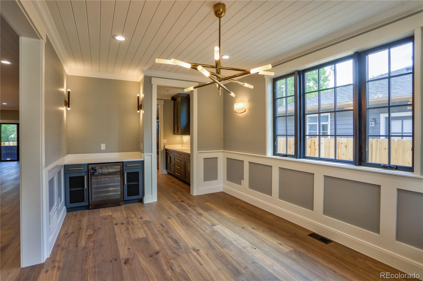 2732 South Jackson Street Denver, CO 80210 - Photo 7 of 40 a view of an empty room with a kitchen and a window