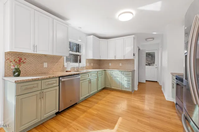 a white refrigerator freezer and a stove sitting inside of a kitchen