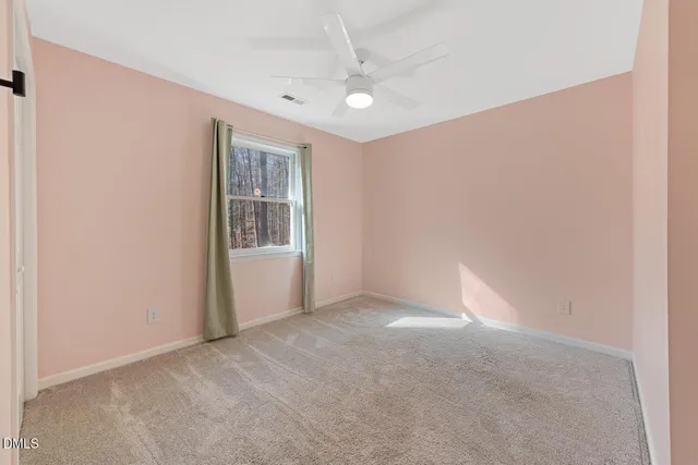 a bedroom with a bed and painting on the wall