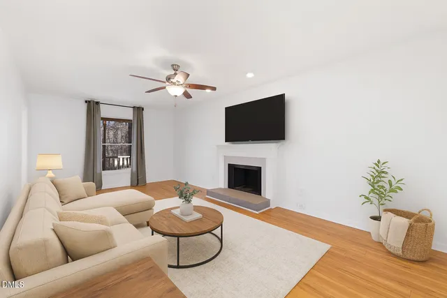 wooden floor fireplace and windows in an empty room