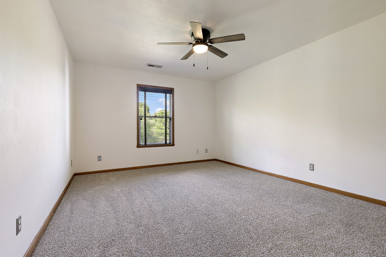 10050 Skipperling Road, Unit 1 Roscoe, IL 61073 - Photo 8 of 15 an empty room with windows and ceiling fan