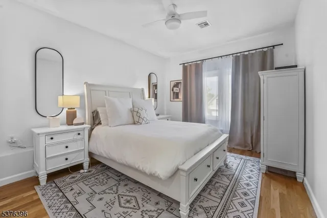 a spacious bedroom with a bed and a dresser