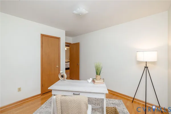 a view of a workspace with furniture and wooden floor