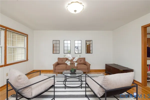 a living room with furniture and a potted plant