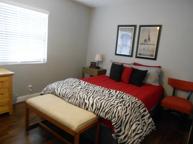 a bedroom with a bed and a window