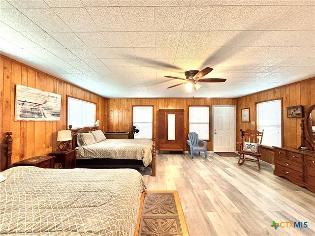 a bed room with a bed and a large window