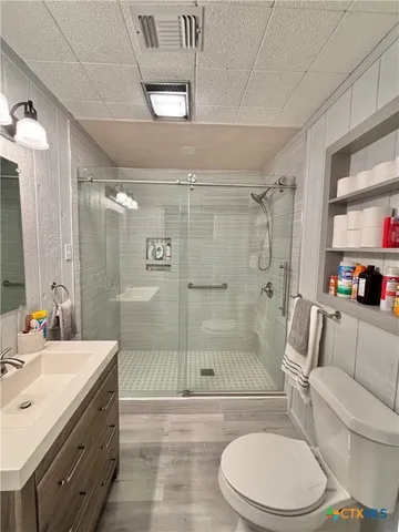 a view of a room with wooden floor and windows