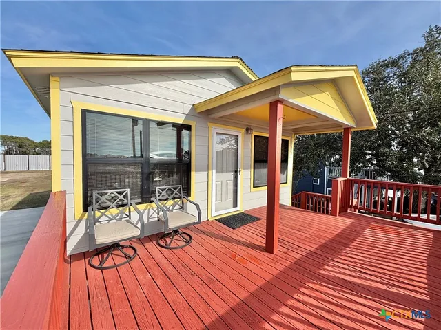 a building outdoor space with patio furniture and potted plants