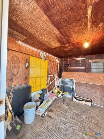 a large bedroom with a bed and wooden floor