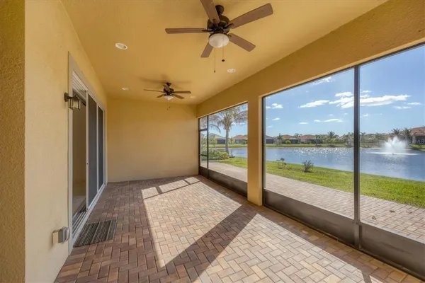 a large kitchen with stainless steel appliances kitchen island granite countertop a large stove a sink dishwasher and white cabinets with wooden floor