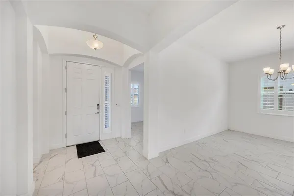 a view of an empty room with glass door and glass door