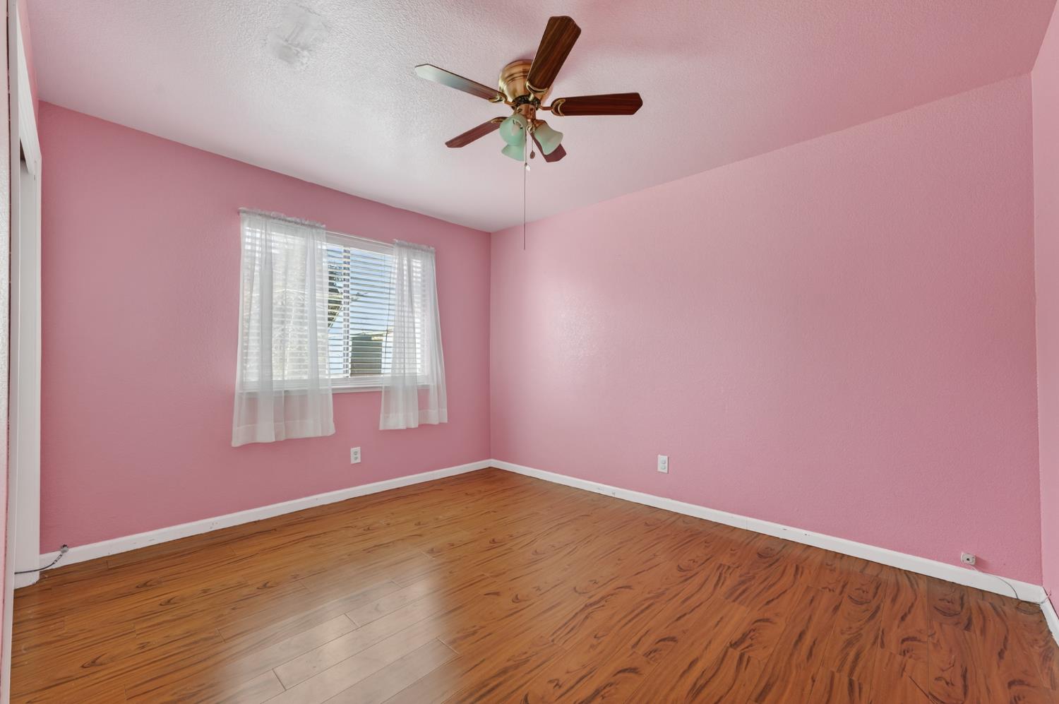 622 Q Street Lincoln, CA 95648 - Photo 13 of 25 an empty room with wooden floor and fan