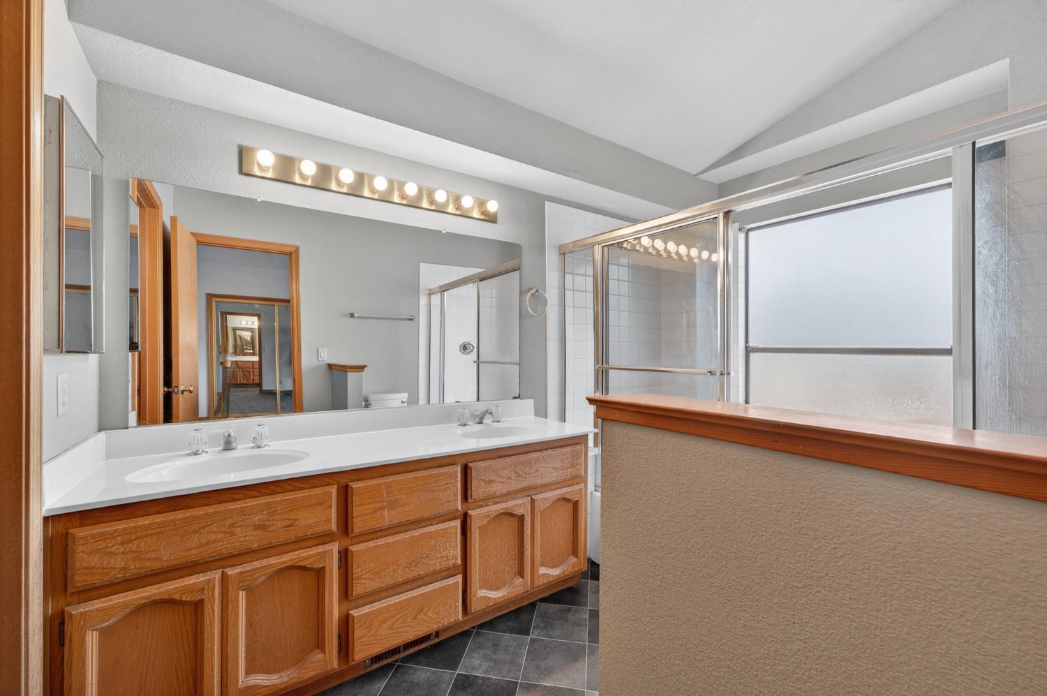 622 Q Street Lincoln, CA 95648 - Photo 18 of 25 a bathroom with a sink a mirror and a shower