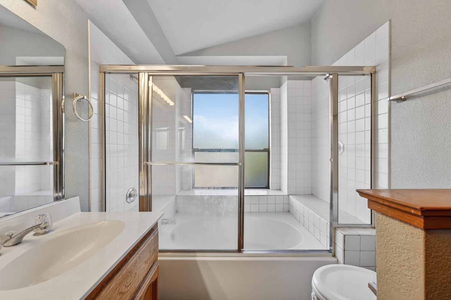 622 Q Street Lincoln, CA 95648 - Photo 19 of 25 a bathroom with a tub shower sink and mirror