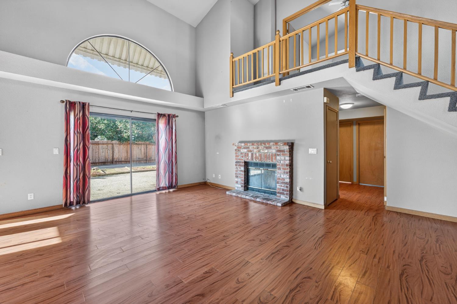 622 Q Street Lincoln, CA 95648 - Photo 4 of 25 a view of an empty room with wooden floor fireplace and a window