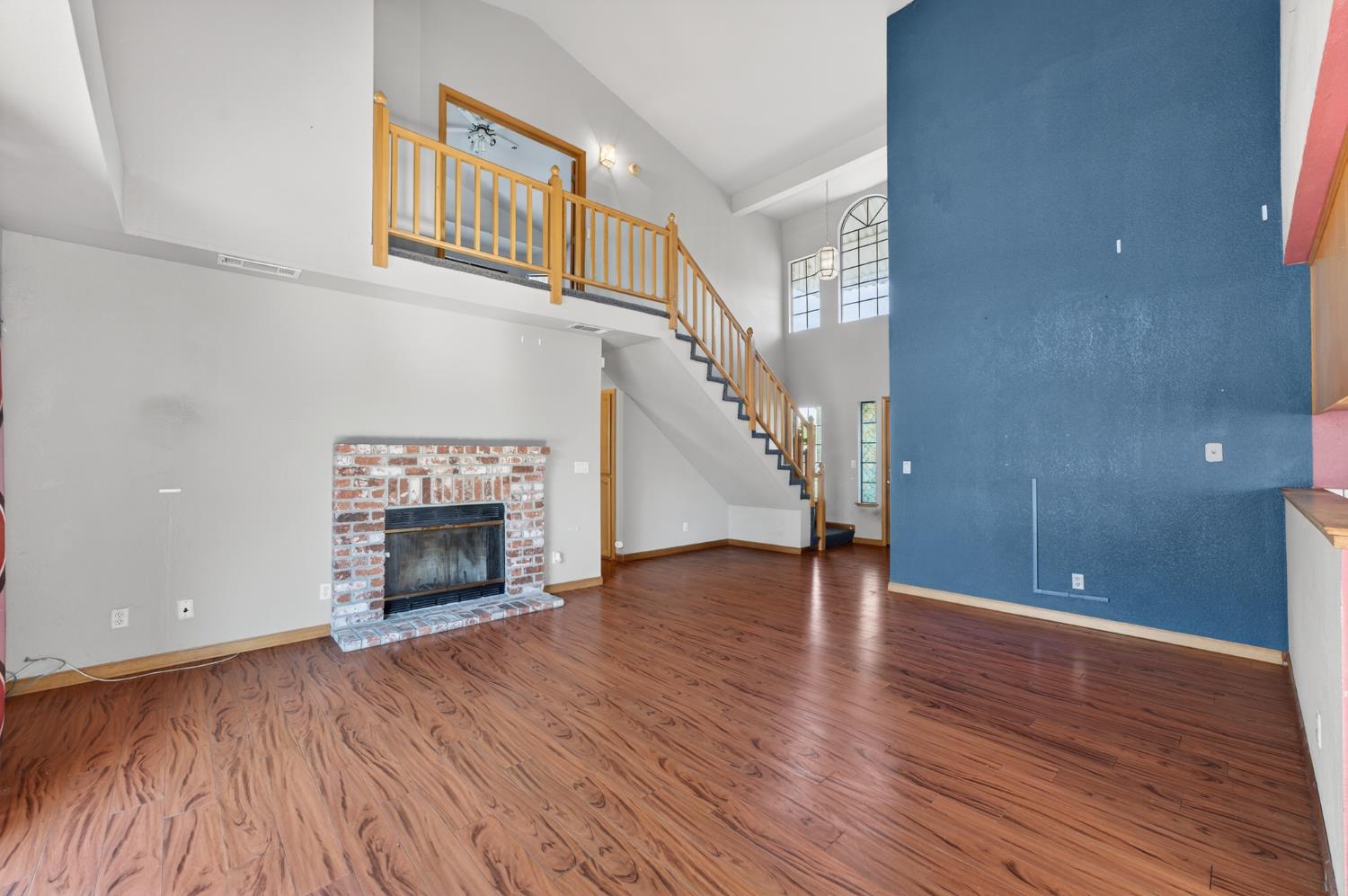 622 Q Street Lincoln, CA 95648 - Photo 5 of 25 a view of an empty room with wooden floor fireplace and a window