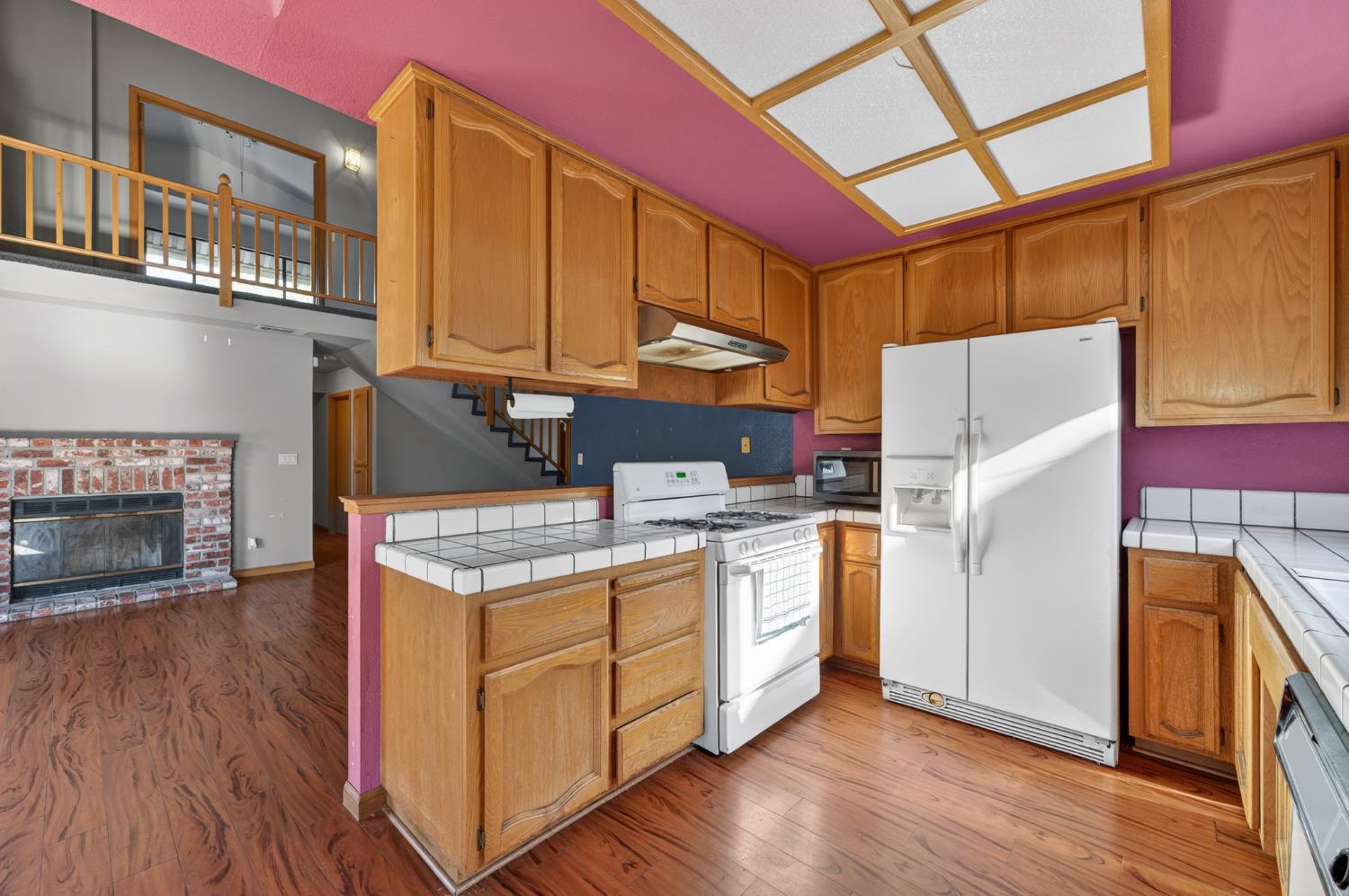 622 Q Street Lincoln, CA 95648 - Photo 8 of 25 a kitchen with stainless steel appliances granite countertop a refrigerator a stove and a wooden floors