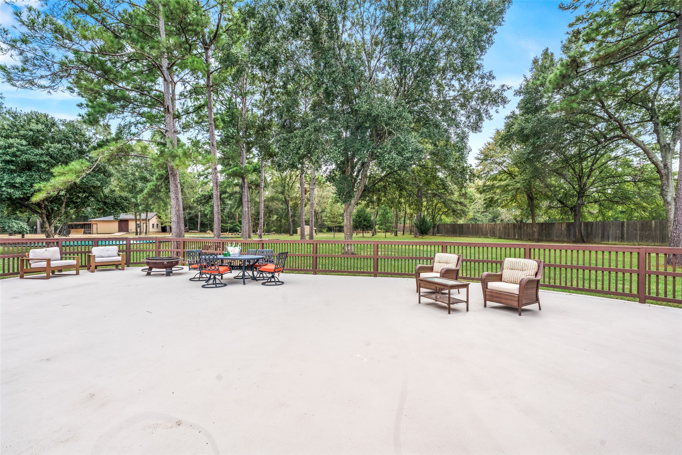 32660 Willow Bend Road Waller, TX 77484 - Photo 43 of 47 Expansive paved patio provides abundant space for outdoor seating, dining, gatherings, and entertaining beneath the shade of mature trees.