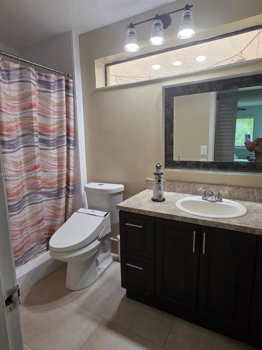 893 Southwest 120th Way Davie, FL 33325 - Photo 15 of 22 a bathroom with a sink toilet and shower