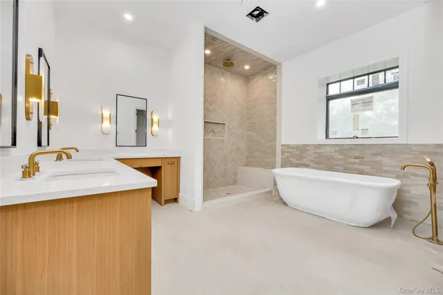 a bathroom with a sink a toilet a mirror and bathtub