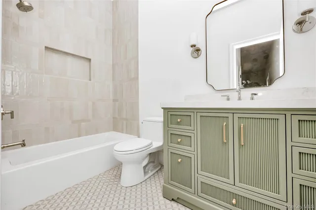 a bathroom with a toilet sink and mirror