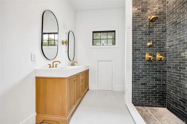 a bathroom with a sink a toilet and a shower